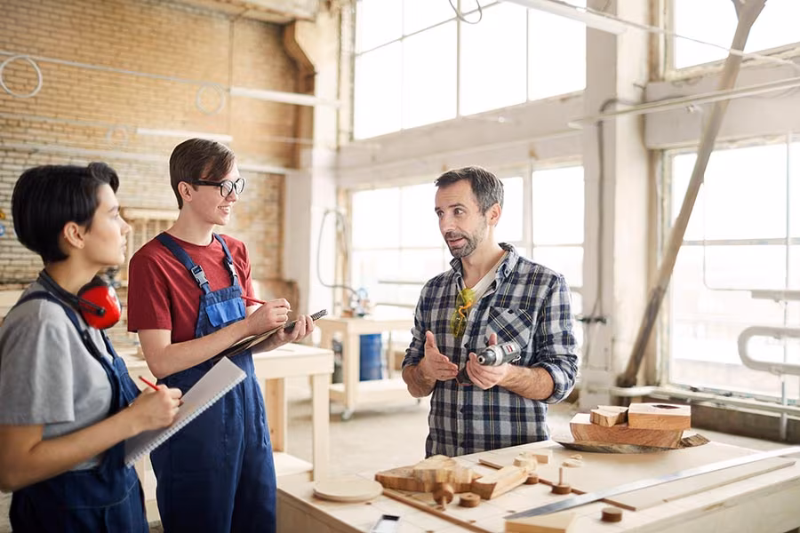 Small business owner mentoring a student intern